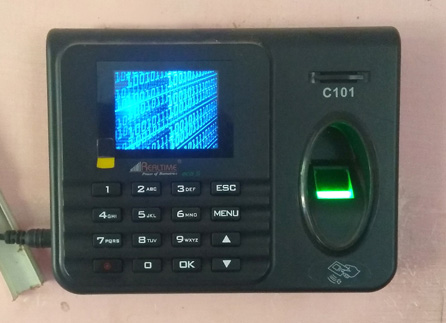 A dirty and well-used biometric c101 fingerprint time-clock.